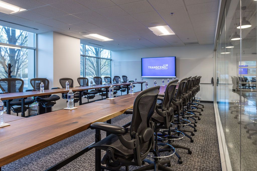 Modern glass-walled boardroom at Brier Creek Corporate Center with executive conference table and professional atmosphere